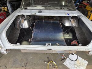 Constructing wheel tubs and trunk floor in Chevy II